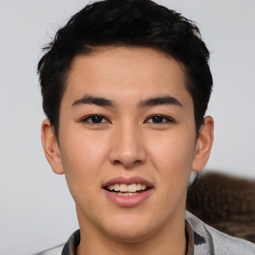 Joyful asian young-adult male with short  brown hair and brown eyes