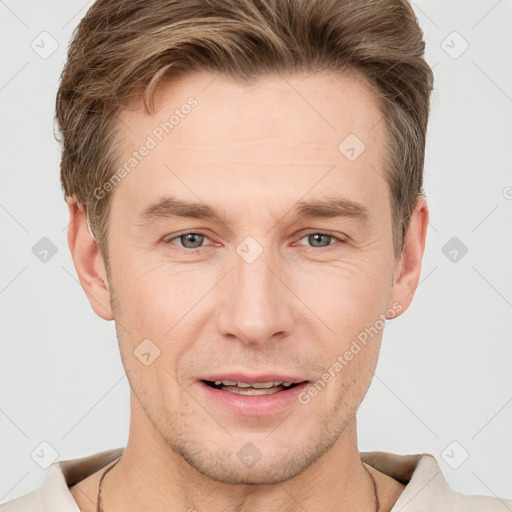 Joyful white young-adult male with short  brown hair and grey eyes