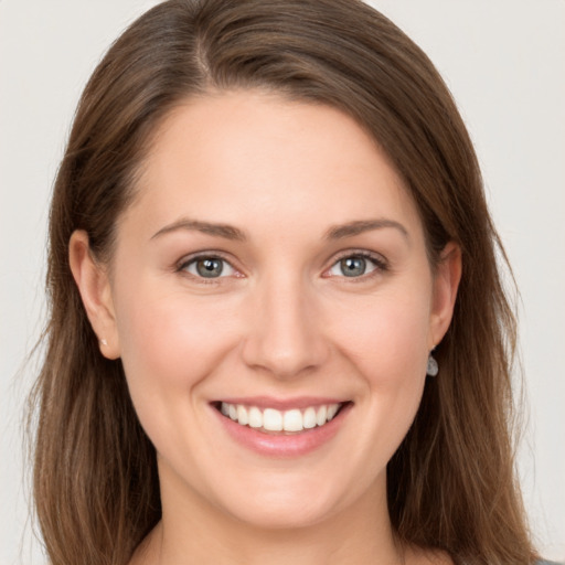 Joyful white young-adult female with long  brown hair and grey eyes