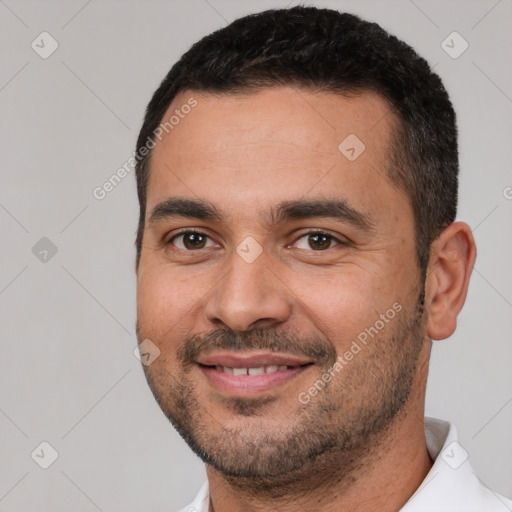 Joyful white young-adult male with short  black hair and brown eyes