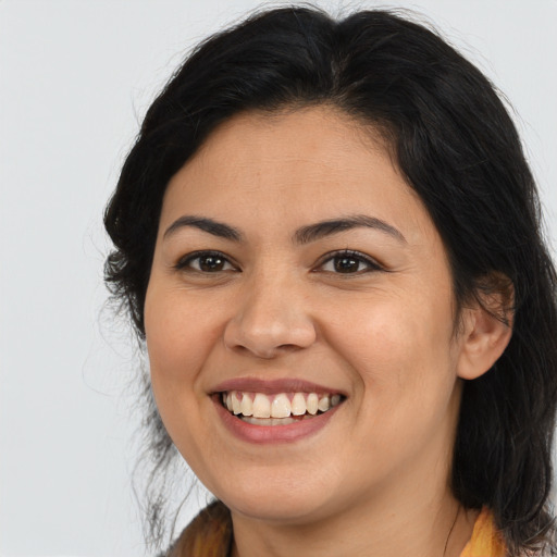 Joyful latino young-adult female with medium  brown hair and brown eyes
