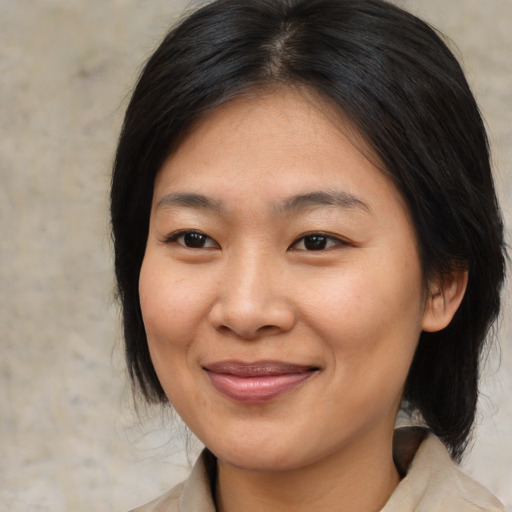 Joyful asian young-adult female with medium  brown hair and brown eyes