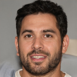 Joyful white adult male with short  brown hair and brown eyes