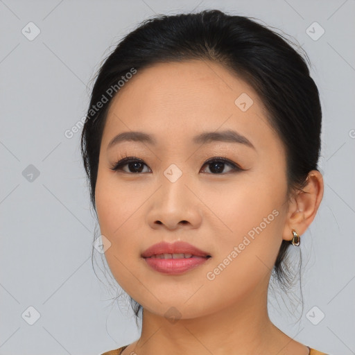 Joyful asian young-adult female with medium  black hair and brown eyes