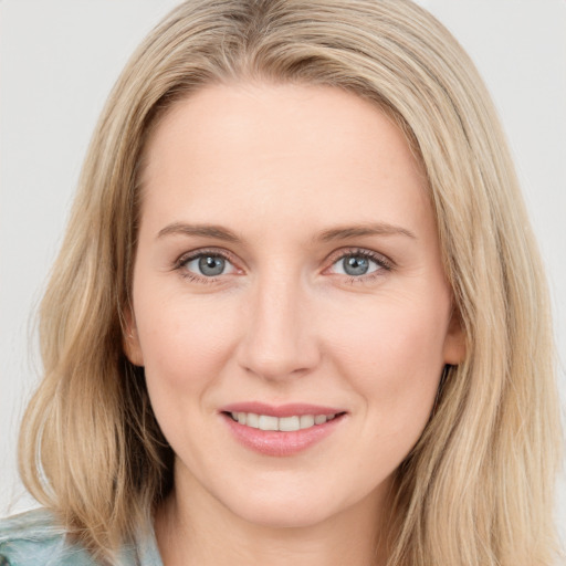 Joyful white young-adult female with long  brown hair and blue eyes