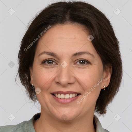 Joyful white adult female with medium  brown hair and brown eyes