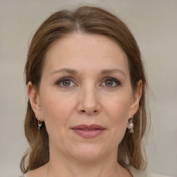 Joyful white adult female with medium  brown hair and grey eyes