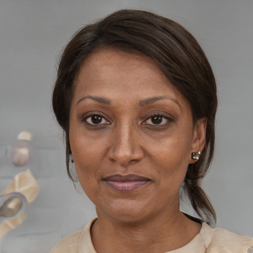 Joyful black adult female with medium  brown hair and brown eyes