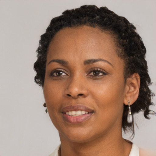 Joyful black young-adult female with medium  black hair and brown eyes