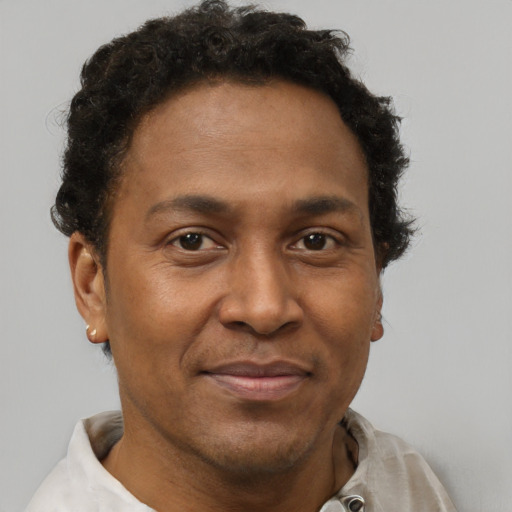 Joyful black adult male with short  brown hair and brown eyes