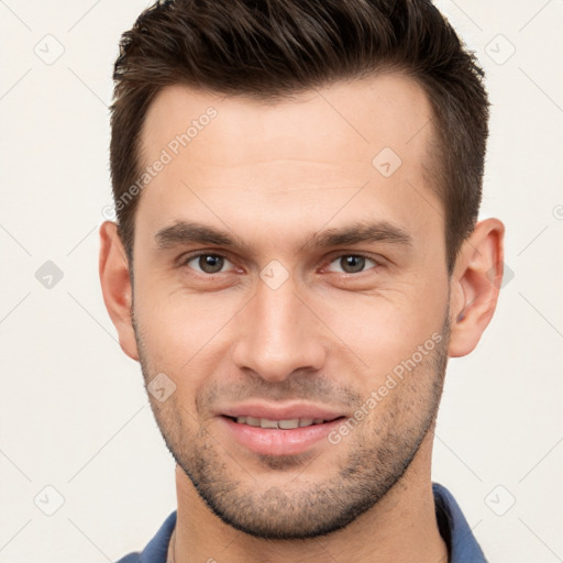 Joyful white young-adult male with short  brown hair and brown eyes