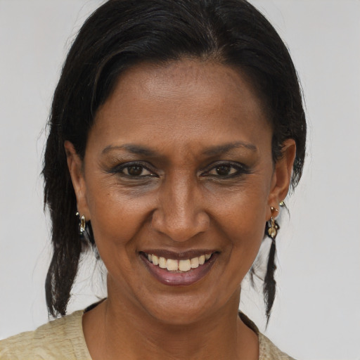 Joyful latino adult female with medium  brown hair and brown eyes