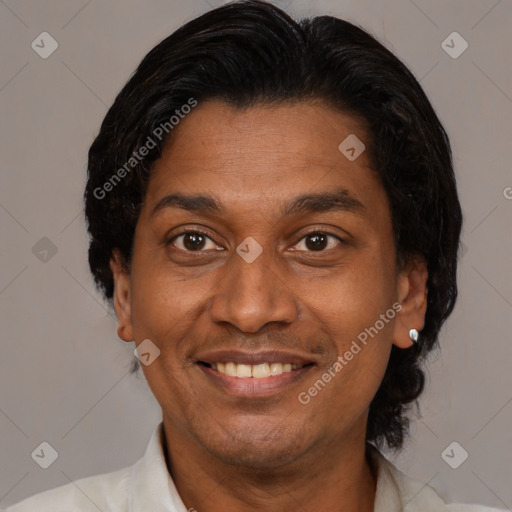 Joyful latino adult male with short  brown hair and brown eyes