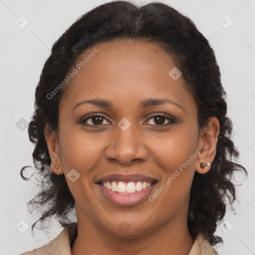 Joyful black adult female with medium  brown hair and brown eyes