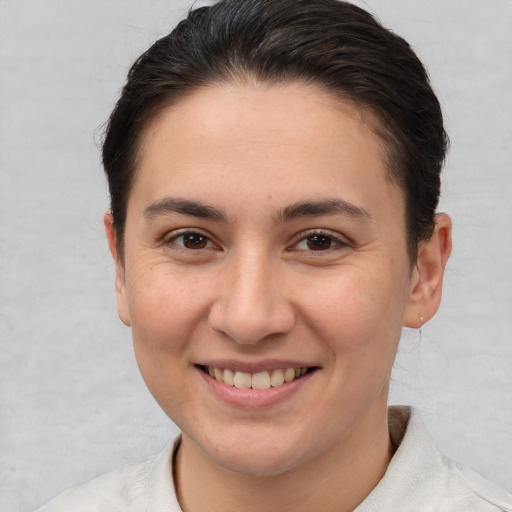 Joyful white young-adult female with short  brown hair and brown eyes