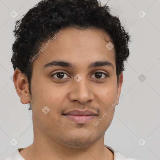 Joyful latino young-adult male with short  brown hair and brown eyes