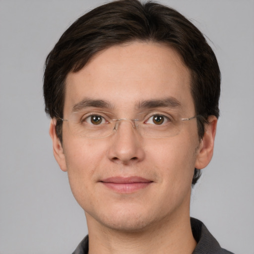 Joyful white young-adult male with short  brown hair and grey eyes