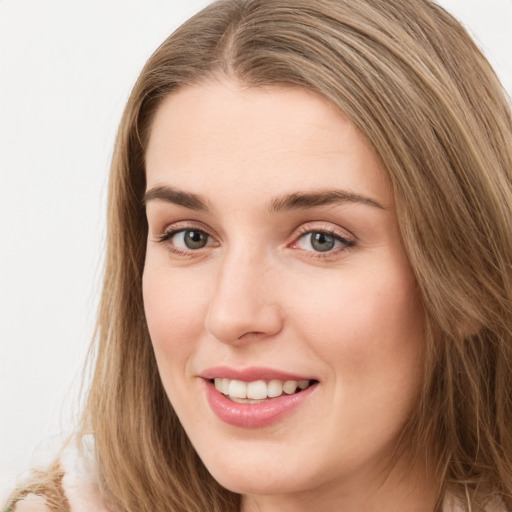 Joyful white young-adult female with long  brown hair and green eyes