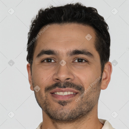 Joyful white young-adult male with short  black hair and brown eyes