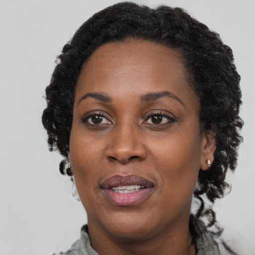 Joyful black young-adult female with short  brown hair and brown eyes