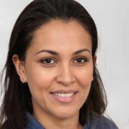 Joyful white adult female with long  brown hair and brown eyes