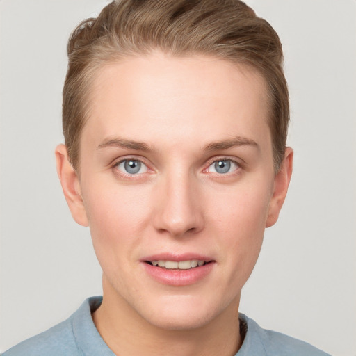 Joyful white young-adult female with short  brown hair and grey eyes