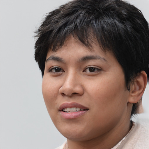Joyful asian young-adult female with short  brown hair and brown eyes