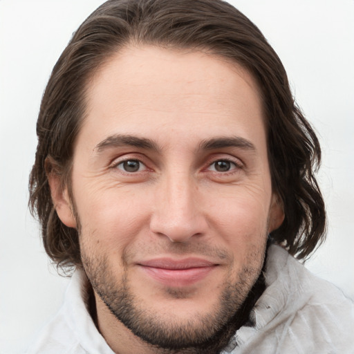 Joyful white young-adult male with medium  brown hair and grey eyes