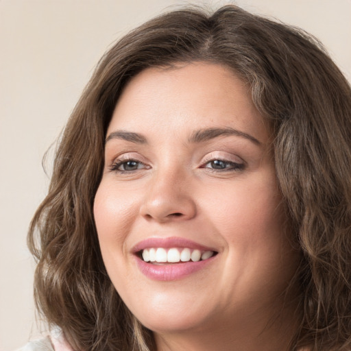 Joyful white young-adult female with medium  brown hair and green eyes