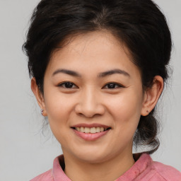 Joyful asian young-adult female with medium  brown hair and brown eyes