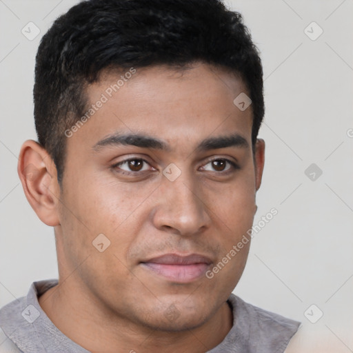 Joyful latino young-adult male with short  brown hair and brown eyes