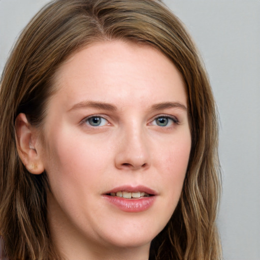 Joyful white young-adult female with long  brown hair and blue eyes