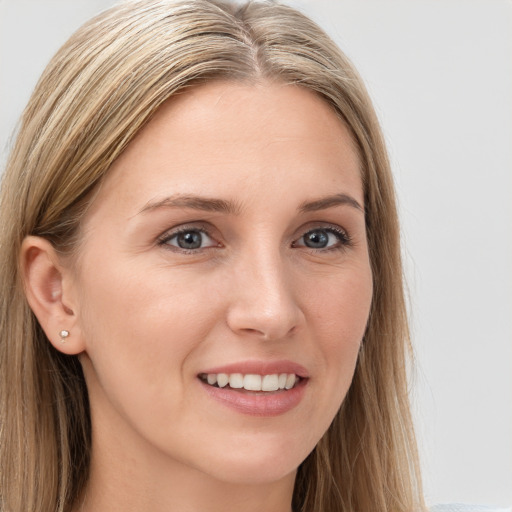 Joyful white young-adult female with long  brown hair and blue eyes