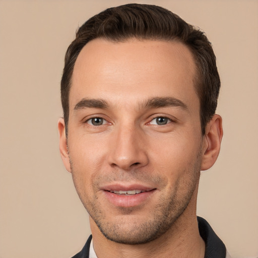 Joyful white young-adult male with short  brown hair and brown eyes