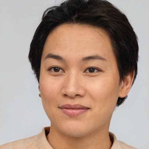 Joyful asian young-adult female with short  brown hair and brown eyes