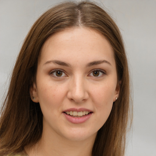 Joyful white young-adult female with long  brown hair and brown eyes