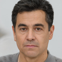 Joyful white adult male with short  black hair and brown eyes