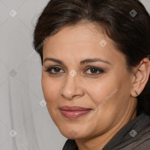 Joyful white adult female with long  brown hair and brown eyes