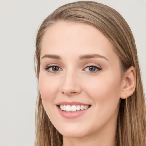 Joyful white young-adult female with long  brown hair and grey eyes