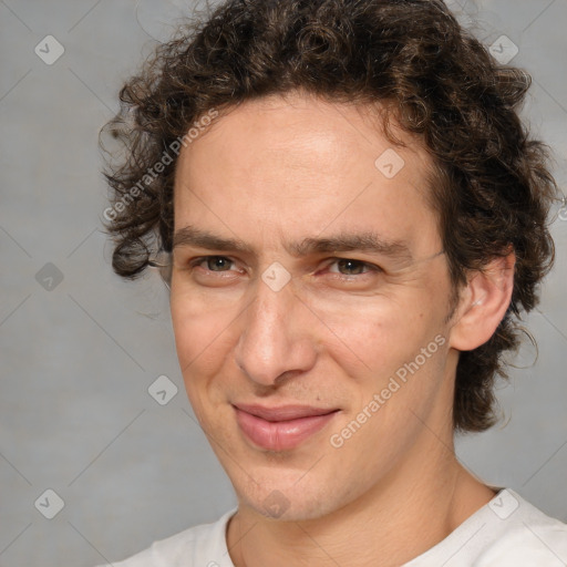 Joyful white adult male with medium  brown hair and brown eyes