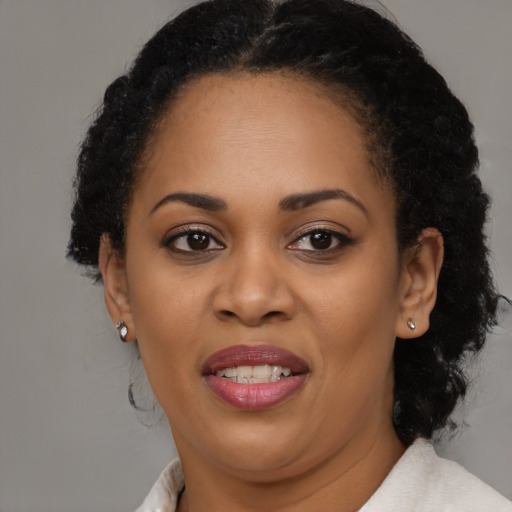 Joyful latino adult female with medium  brown hair and brown eyes