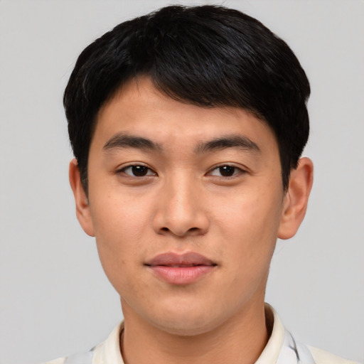 Joyful asian young-adult male with short  black hair and brown eyes