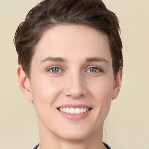 Joyful white young-adult female with short  brown hair and grey eyes