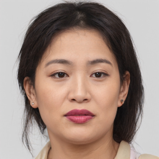 Joyful asian young-adult female with medium  brown hair and brown eyes