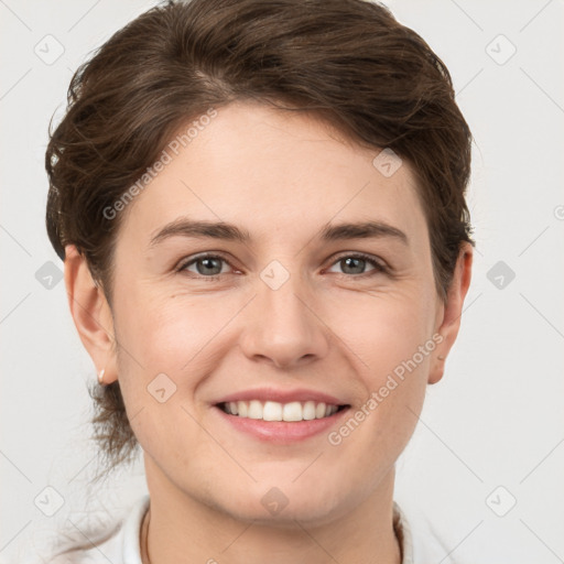 Joyful white young-adult female with short  brown hair and grey eyes