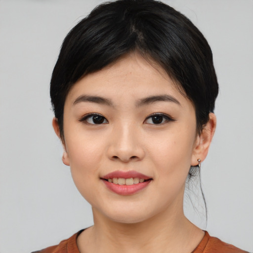 Joyful asian young-adult female with medium  black hair and brown eyes