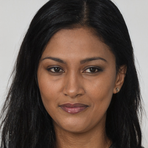 Joyful asian young-adult female with long  black hair and brown eyes