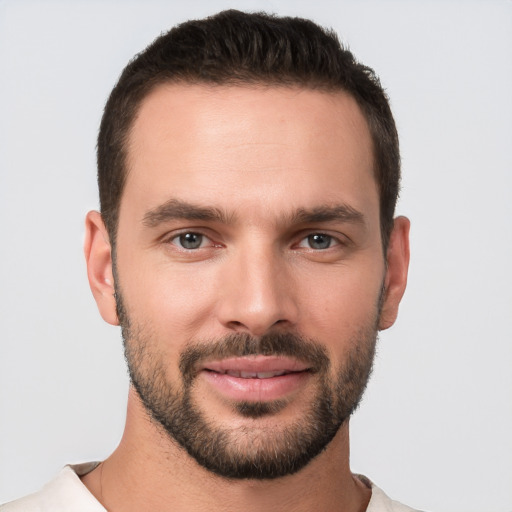 Joyful white young-adult male with short  brown hair and brown eyes