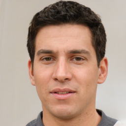 Joyful white adult male with short  brown hair and grey eyes