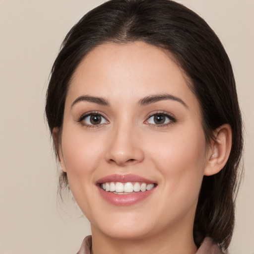 Joyful white young-adult female with medium  brown hair and brown eyes